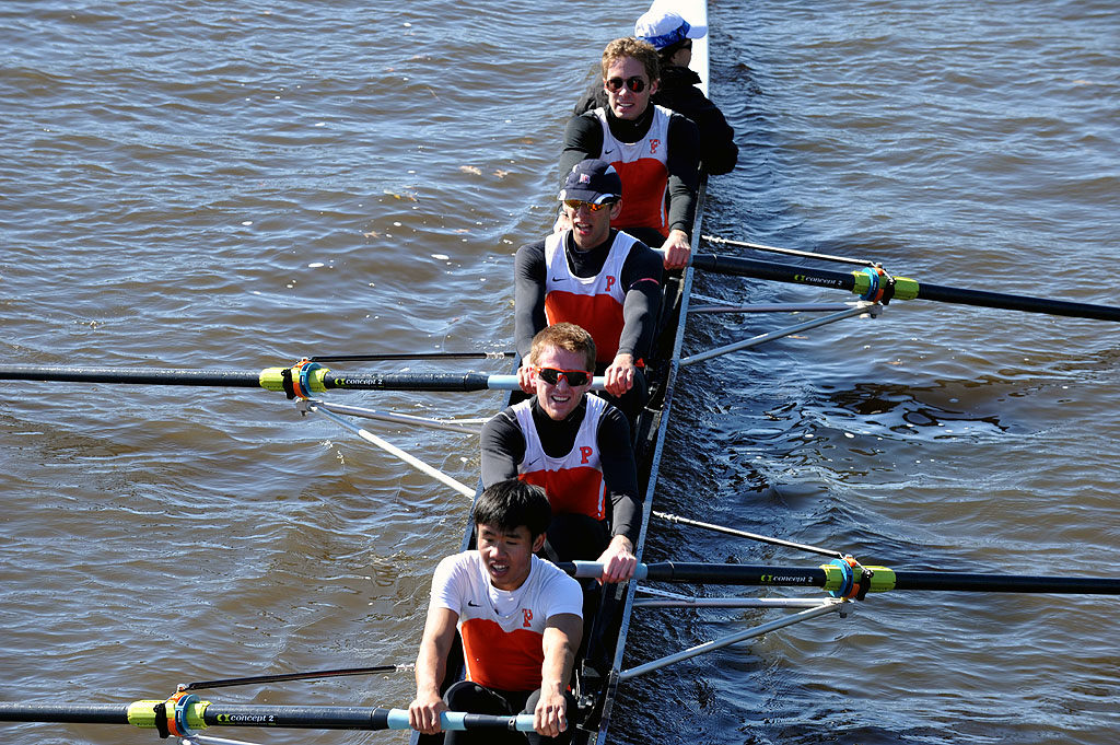 A man rowing a boat in a body of water