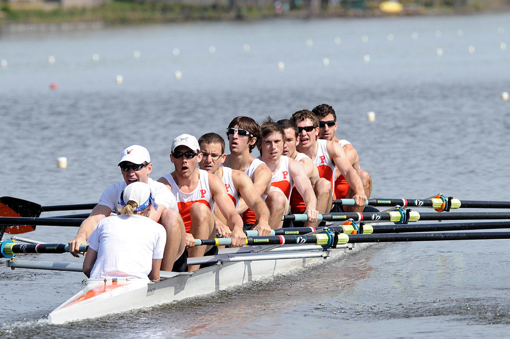 A group of people rowing a boat in the water