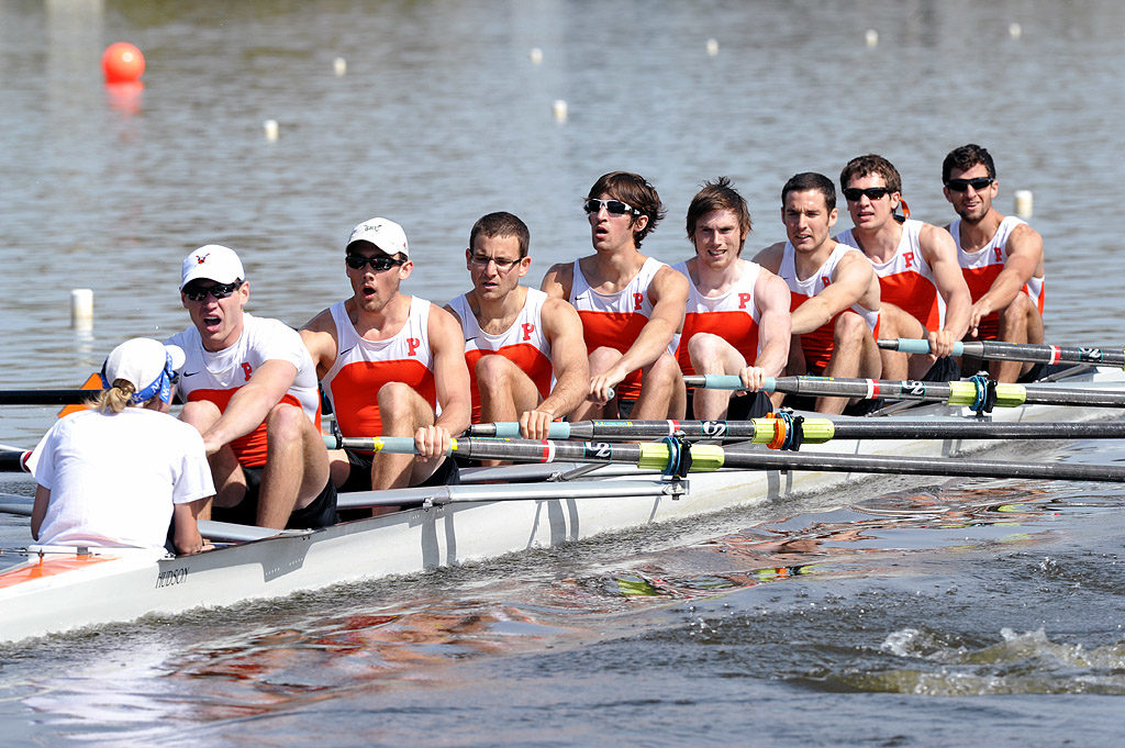 A group of people rowing a boat in the water