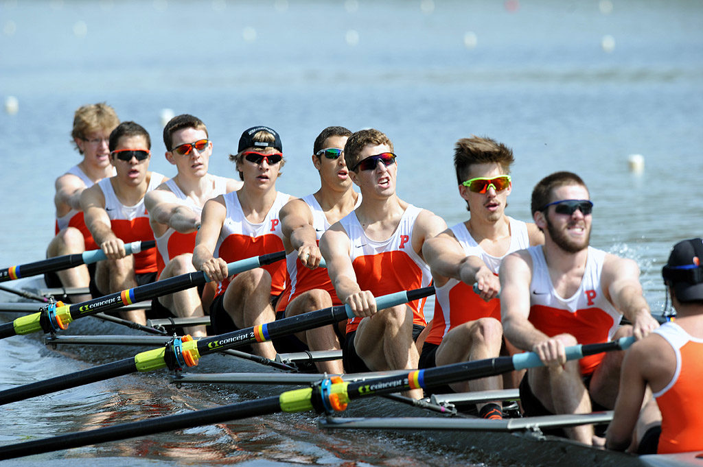 A group of people rowing a boat in the water