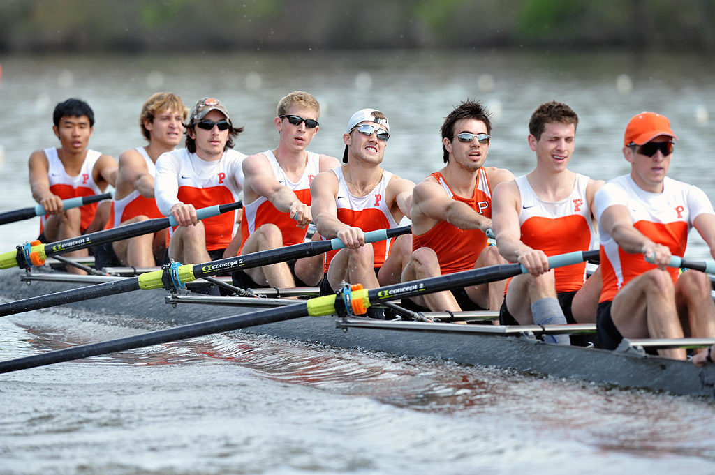 A group of people rowing a boat in the water