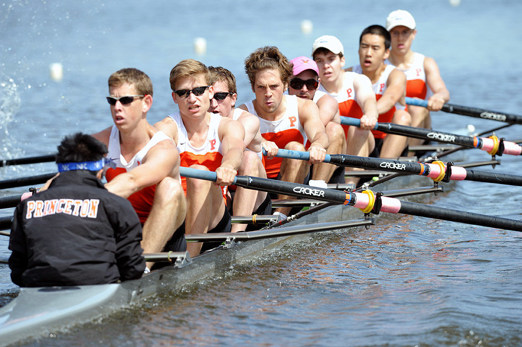 A group of people rowing a boat in the water