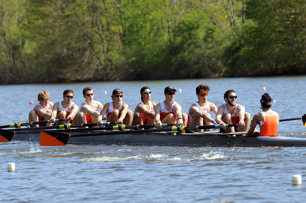 A group of people rowing a boat in the water