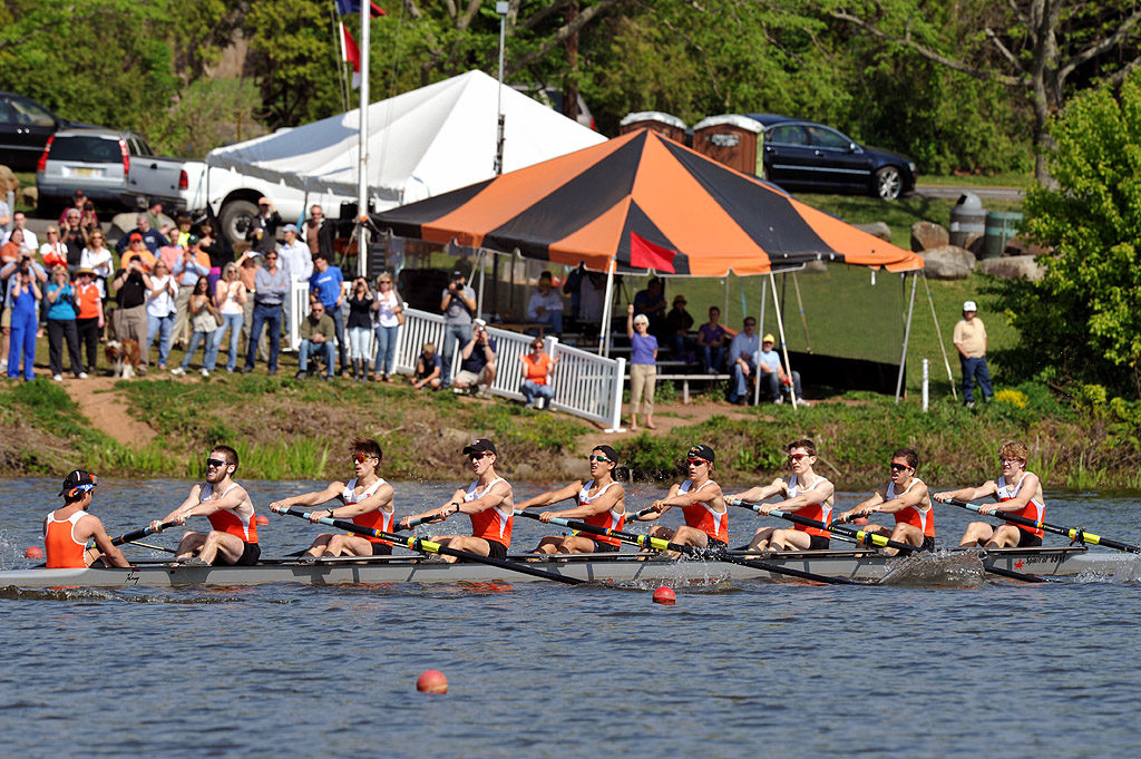 A group of people rowing a boat in the water