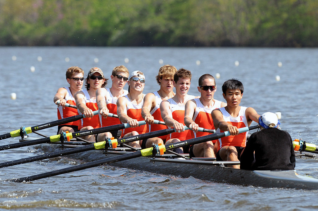 A group of people rowing a boat in the water