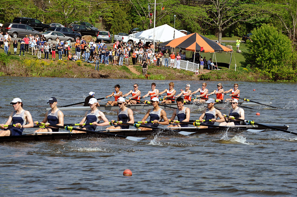 A group of people rowing a boat in the water