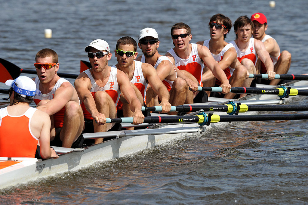 A group of people rowing a boat in the water