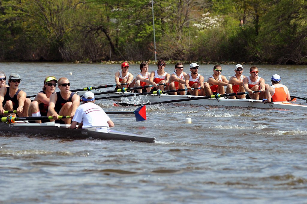 A group of people rowing a boat in a body of water