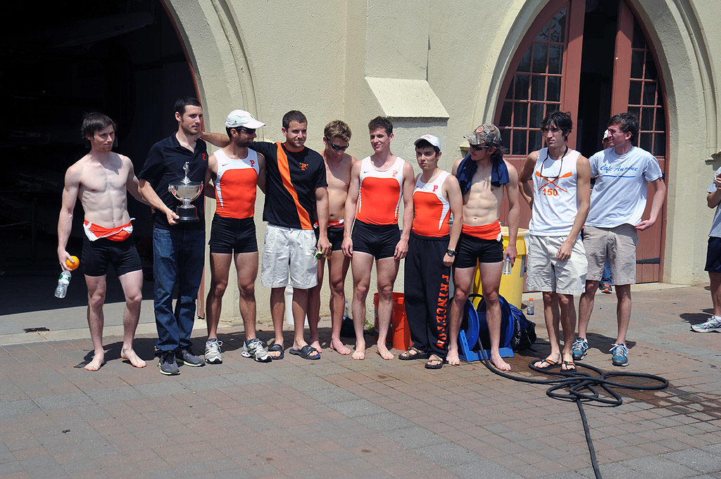 A group of people standing in front of a crowd posing for the camera