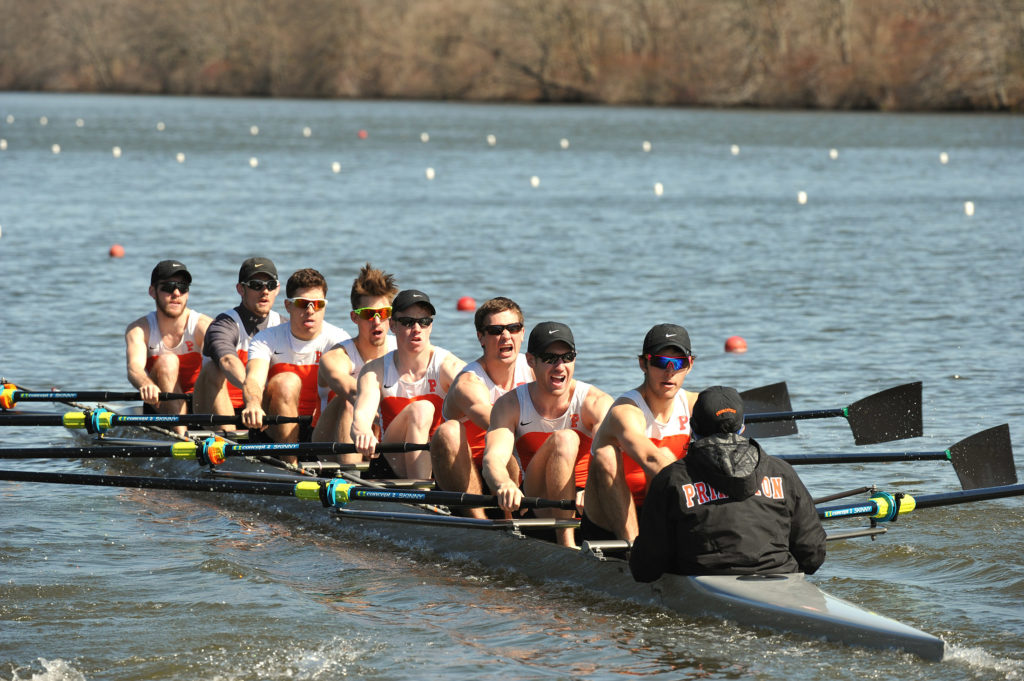 A group of people rowing a boat in the water