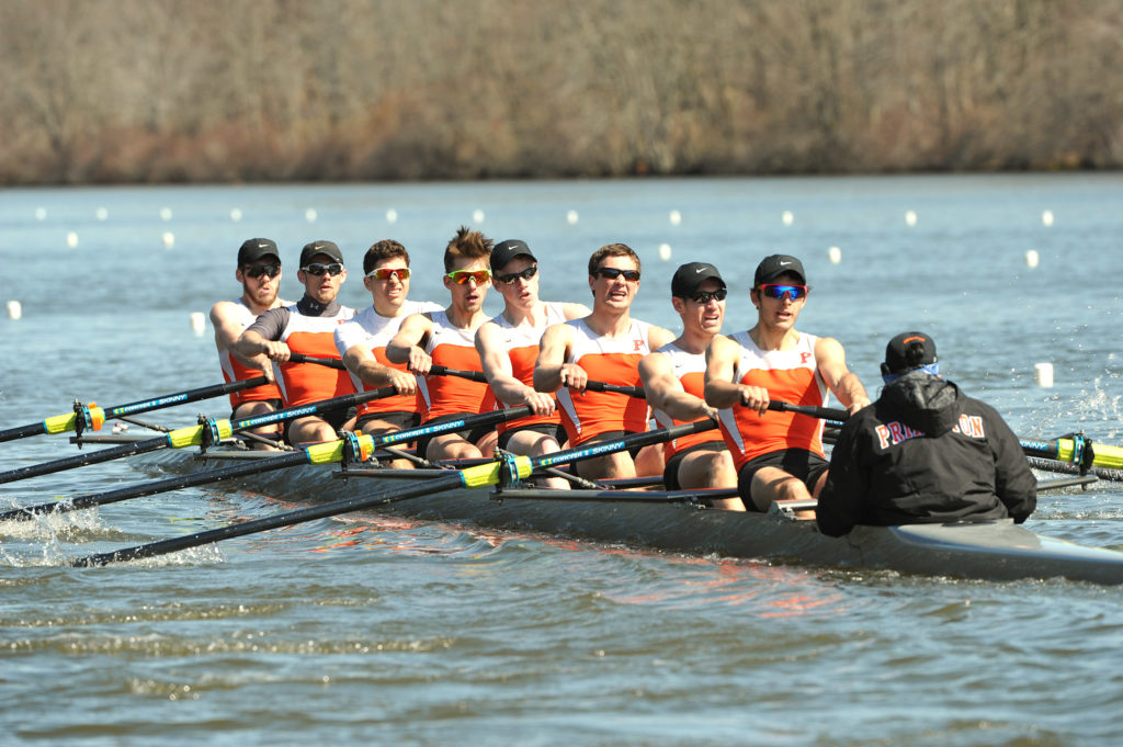 A group of people rowing a boat in the water