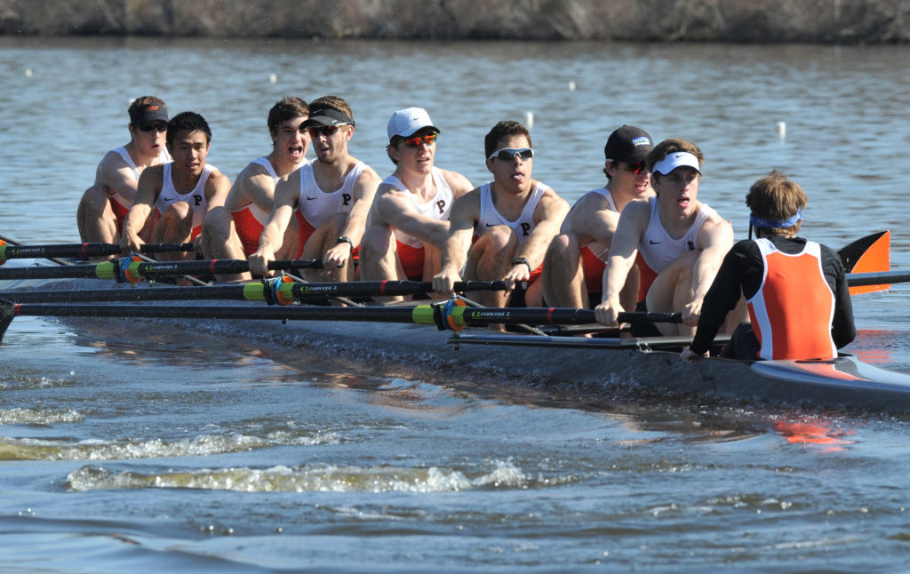 A group of people rowing a boat in the water