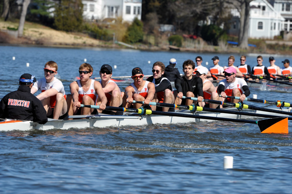 A group of people rowing a boat in the water