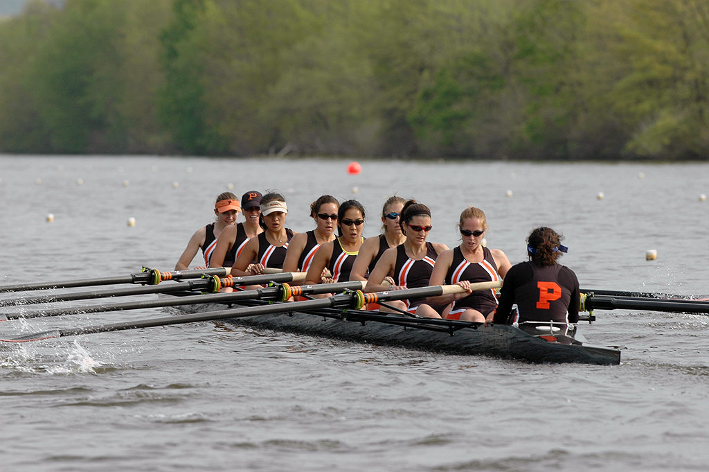 A group of people rowing a boat in the water