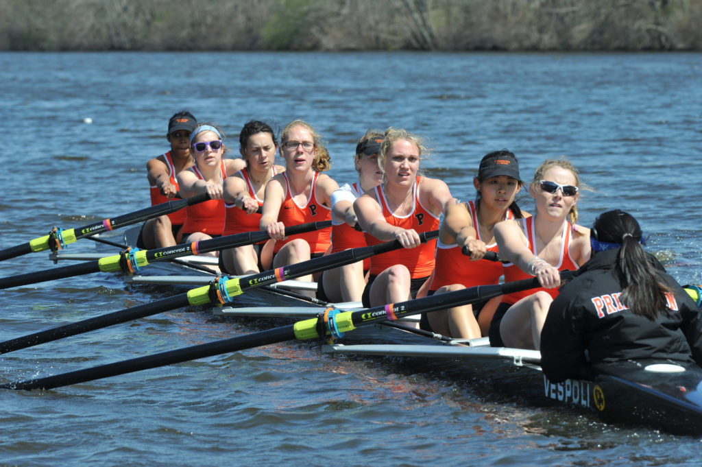 A group of people rowing a boat in the water