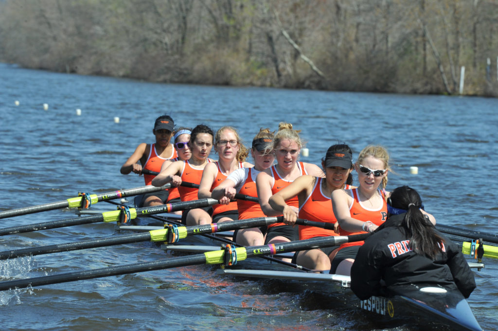 A group of people rowing a boat in the water