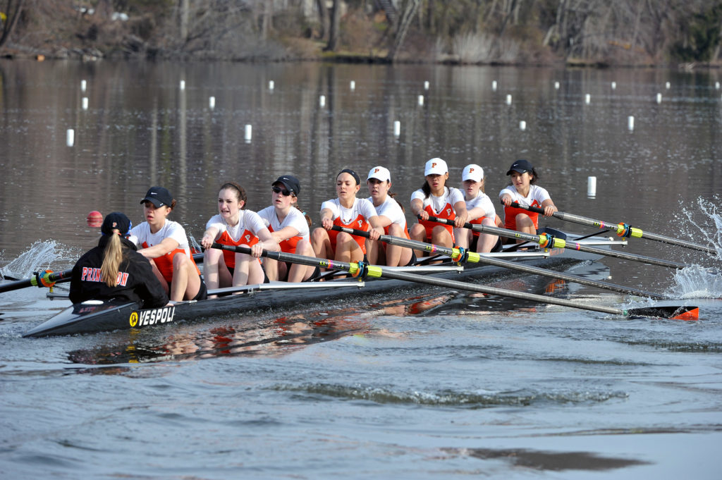 A group of people rowing a boat in the water