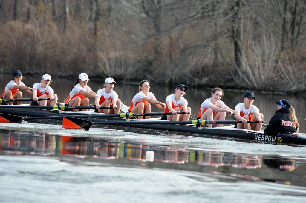 A group of people rowing a boat in the water