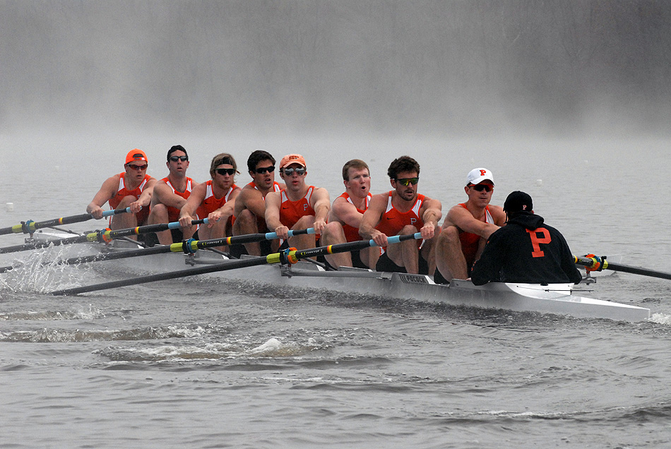 A group of people rowing a boat in the water