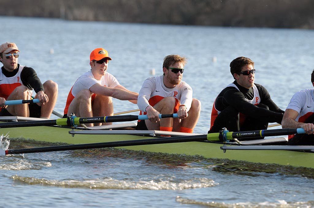 A group of people rowing a boat in the water