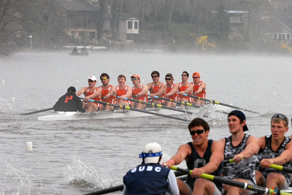 A group of people rowing a boat in the water