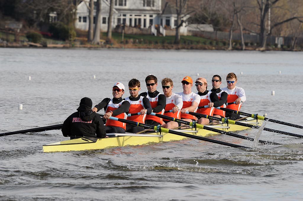 A group of people rowing a boat in the water