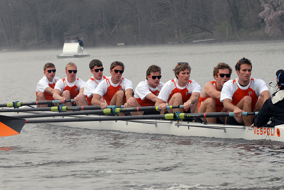 A group of people rowing a boat in the water