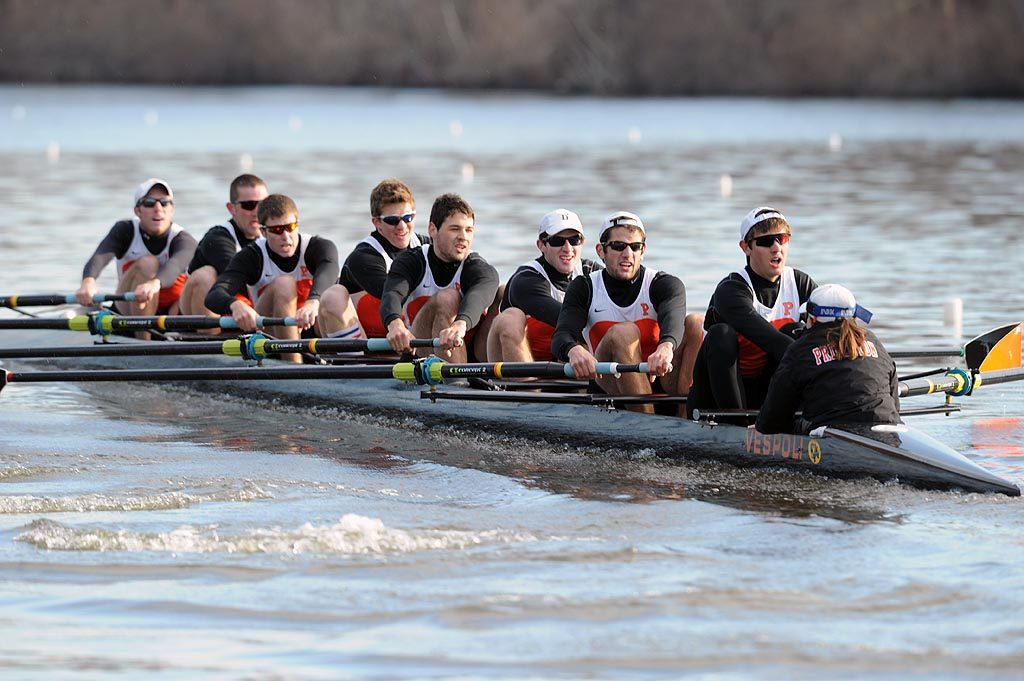 A group of people rowing a boat in the water