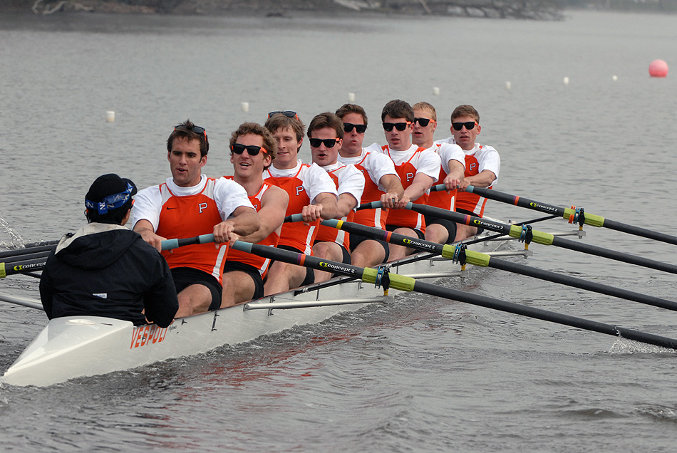 A group of people rowing a boat in the water