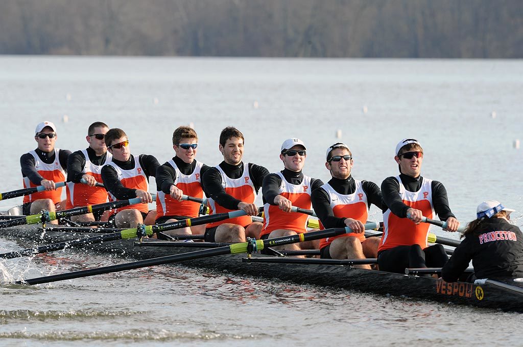 A group of people rowing a boat in the water