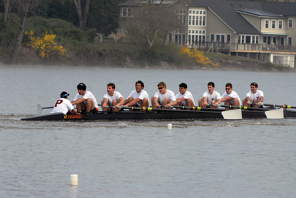 A group of people rowing a boat in the water