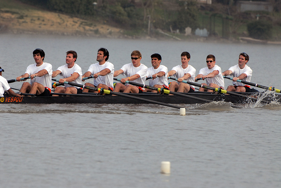 A group of people rowing a boat in the water