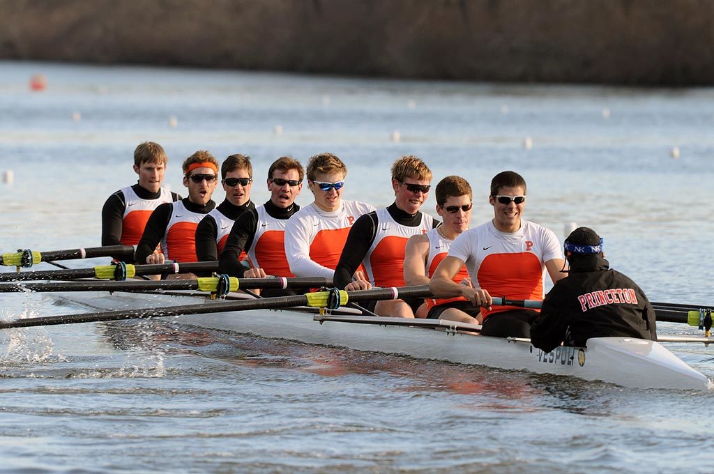 A group of people rowing a boat in the water