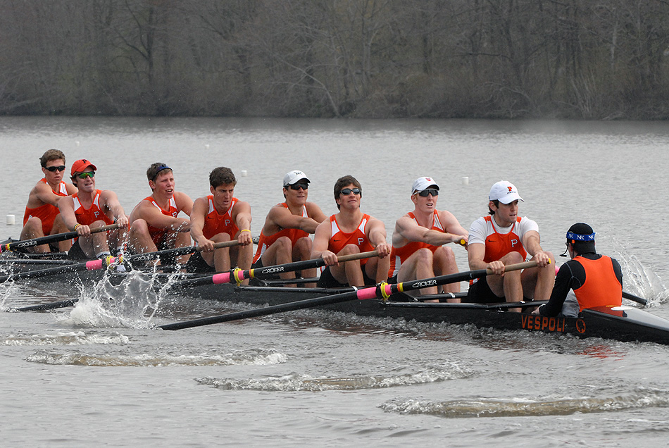 A group of people rowing a boat in the water