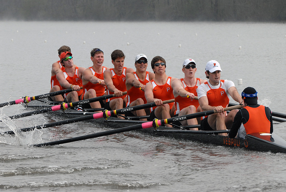 A group of people rowing a boat in the water