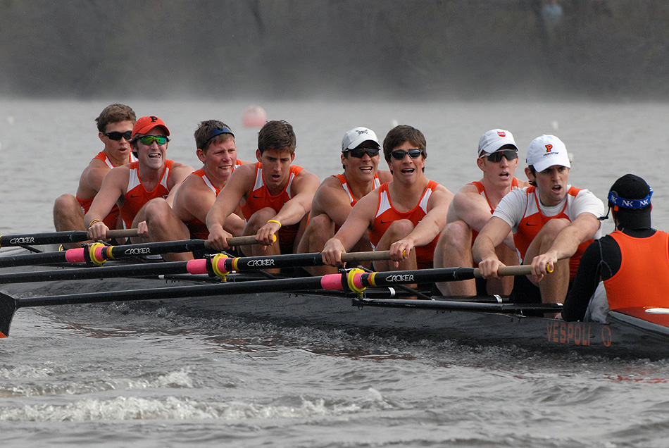 A group of people rowing a boat in the water