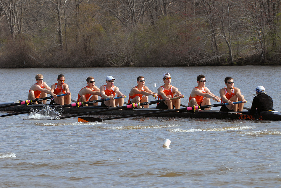 A group of people rowing a boat in the water