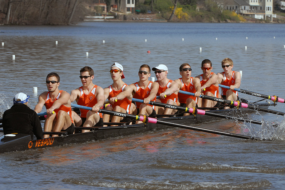 A group of people rowing a boat in the water