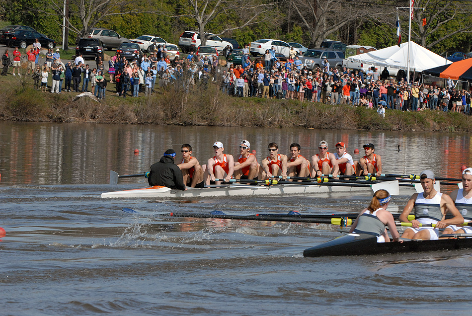 A group of people rowing a boat in the water