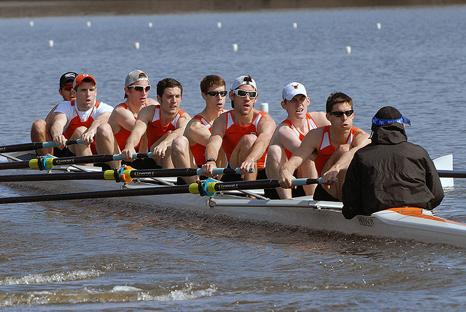 A group of people rowing a boat in the water