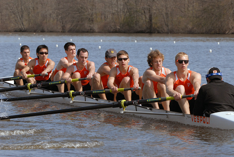 A group of people rowing a boat in the water