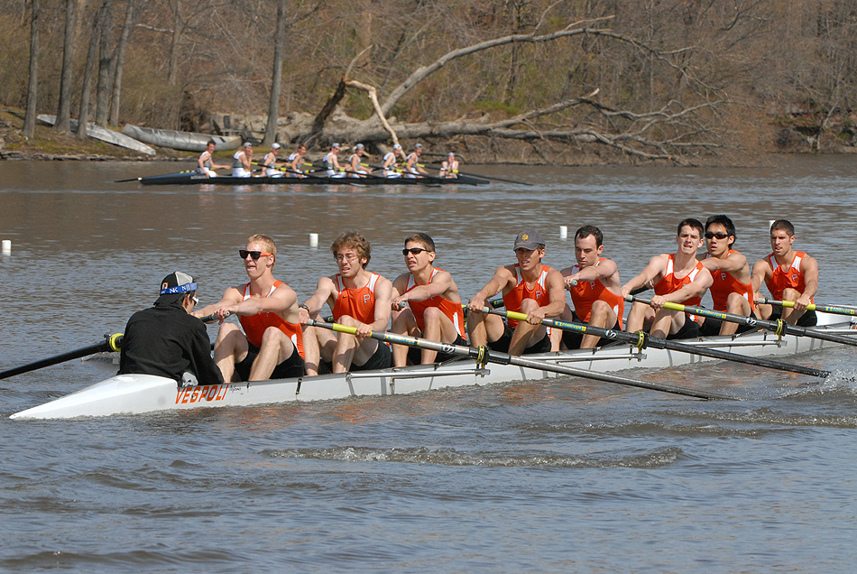 A group of people rowing a boat in the water