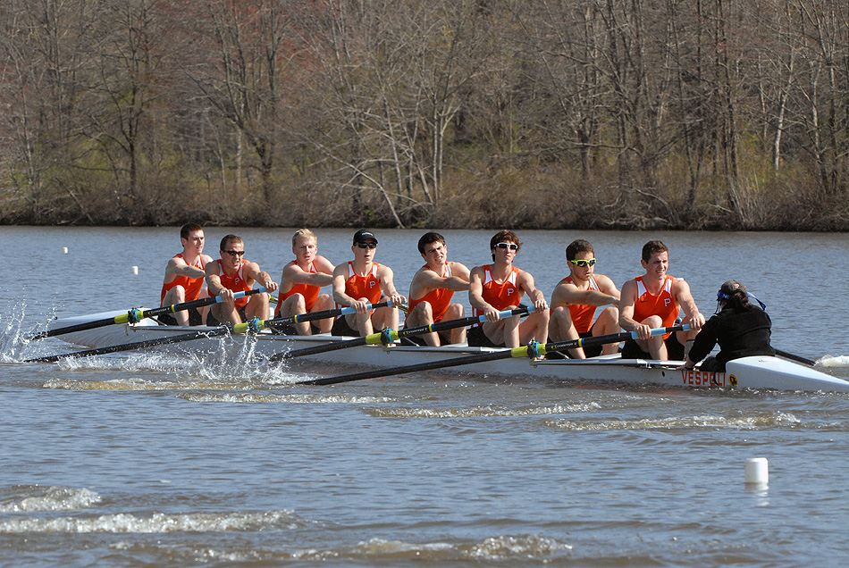 A group of people rowing a boat in the water