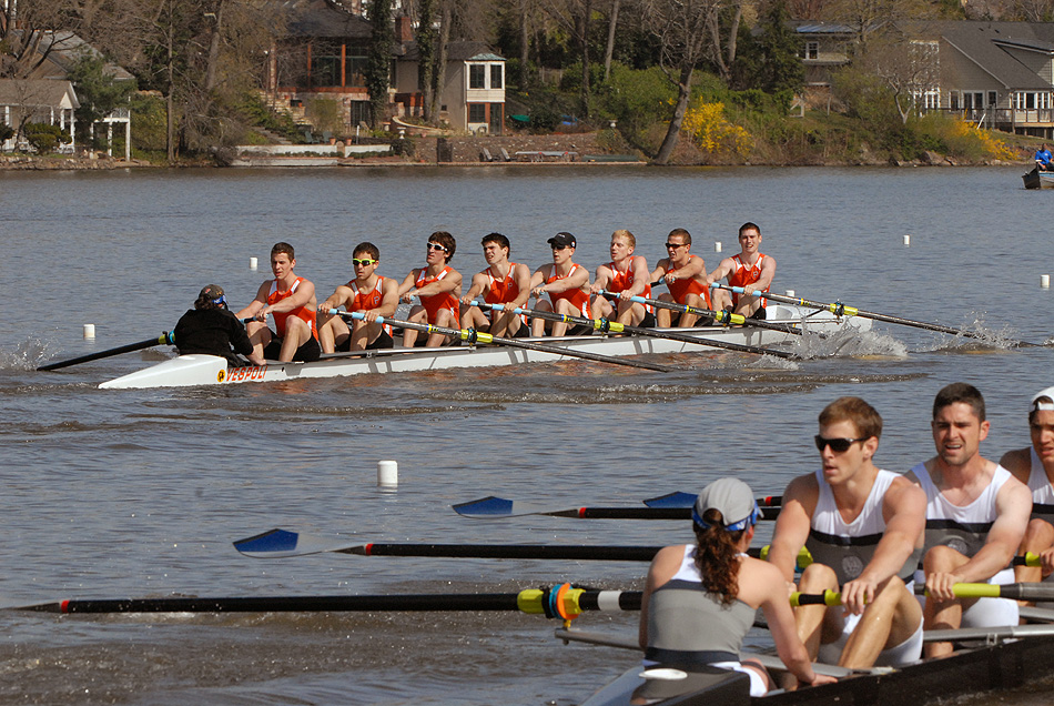 A group of people rowing a boat in the water