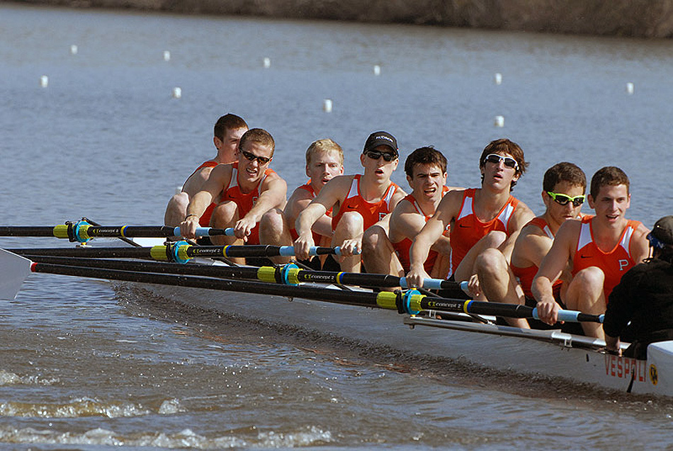 A group of people rowing a boat in the water