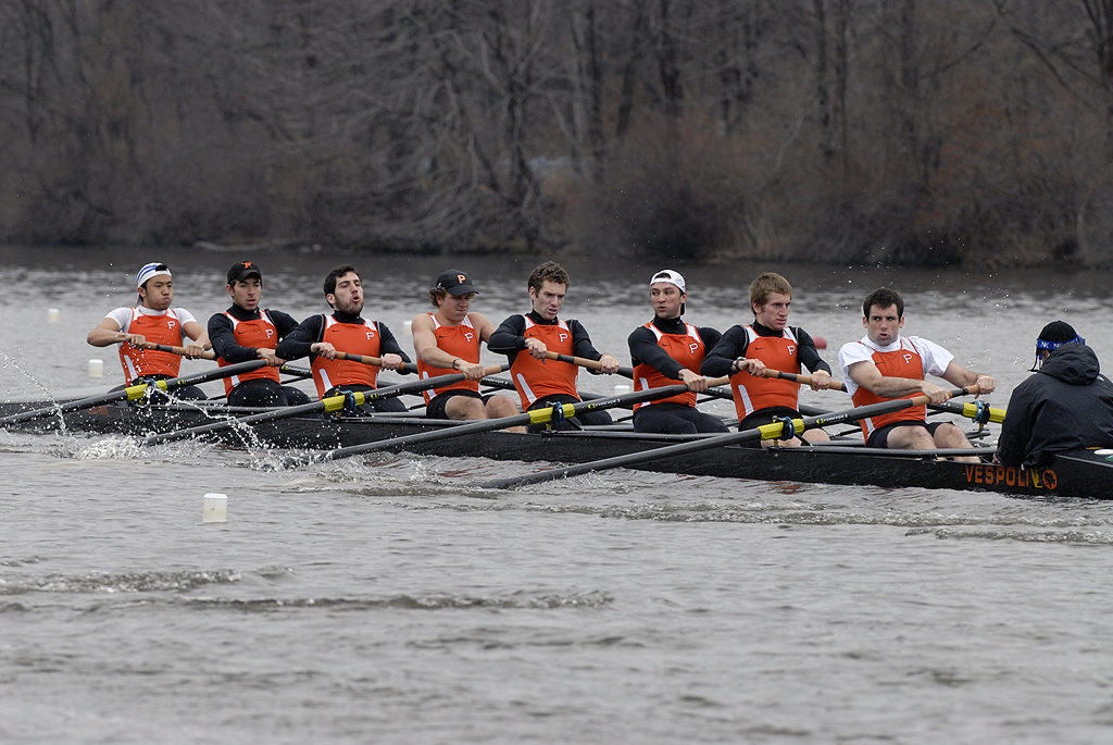 A group of people rowing a boat in the water