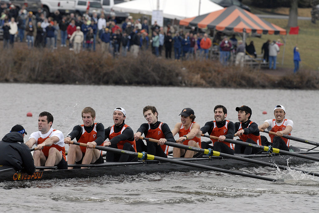 A group of people rowing a canoe