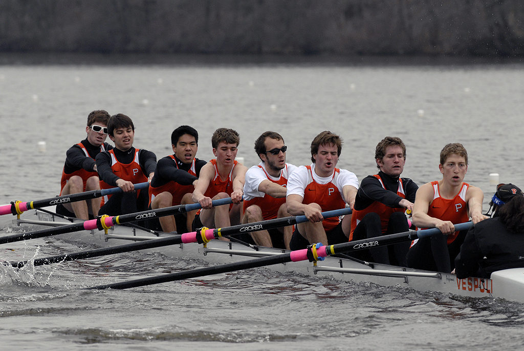 A group of people rowing a boat in the water