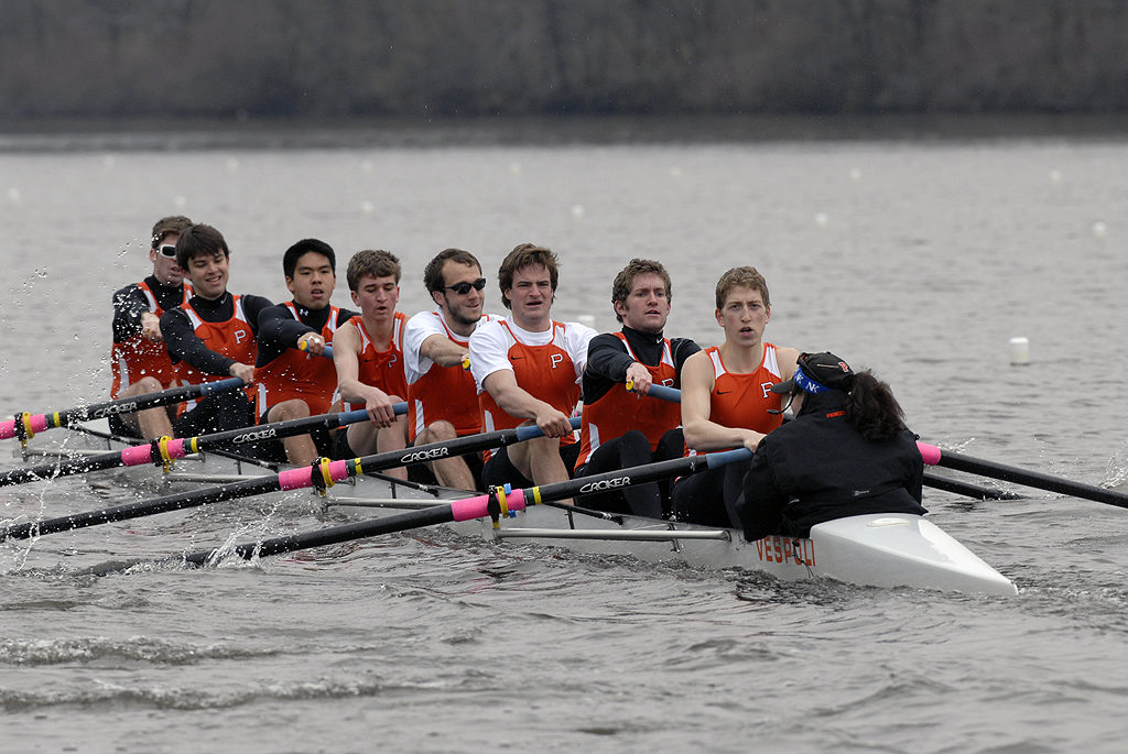 A group of people rowing a boat in the water