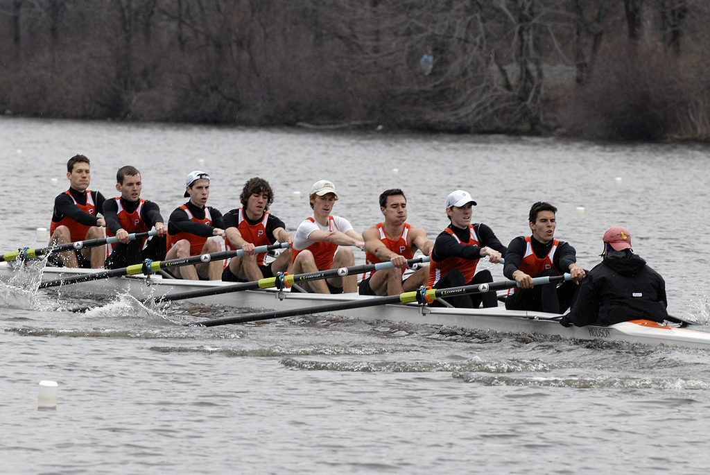 A group of people rowing a boat in the water